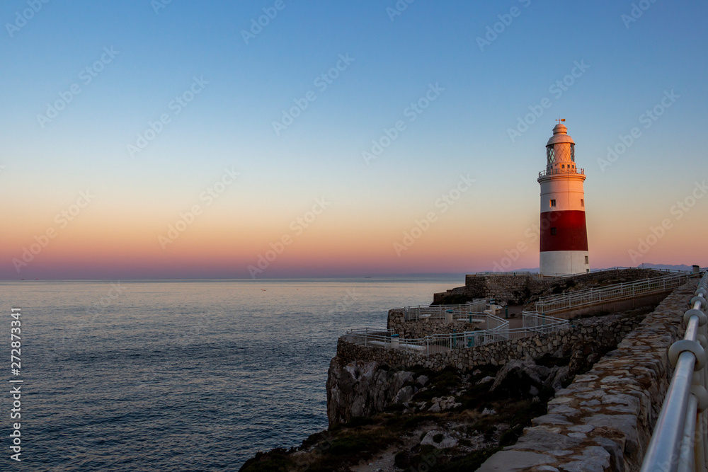 Europa Point Lighthouse, Trinity Lighthouse at Europa Point or Victoria Tower in Gibraltar at sunset Europa Point Lighthouse, Trinity Lighthouse at Europa Point or Victoria Tower in Gibraltar at sunset