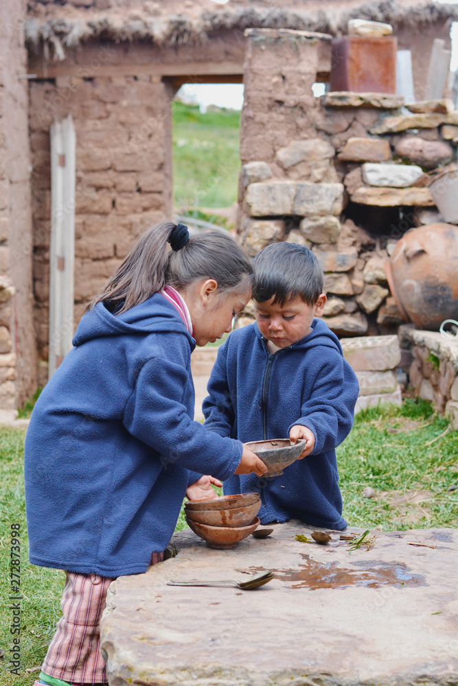 Little latin siblings holding empty dishes. Little latin siblings holding empty dishes.