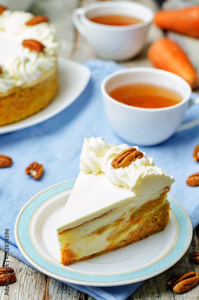 carrot cake cheesecake with pecan on a wood background