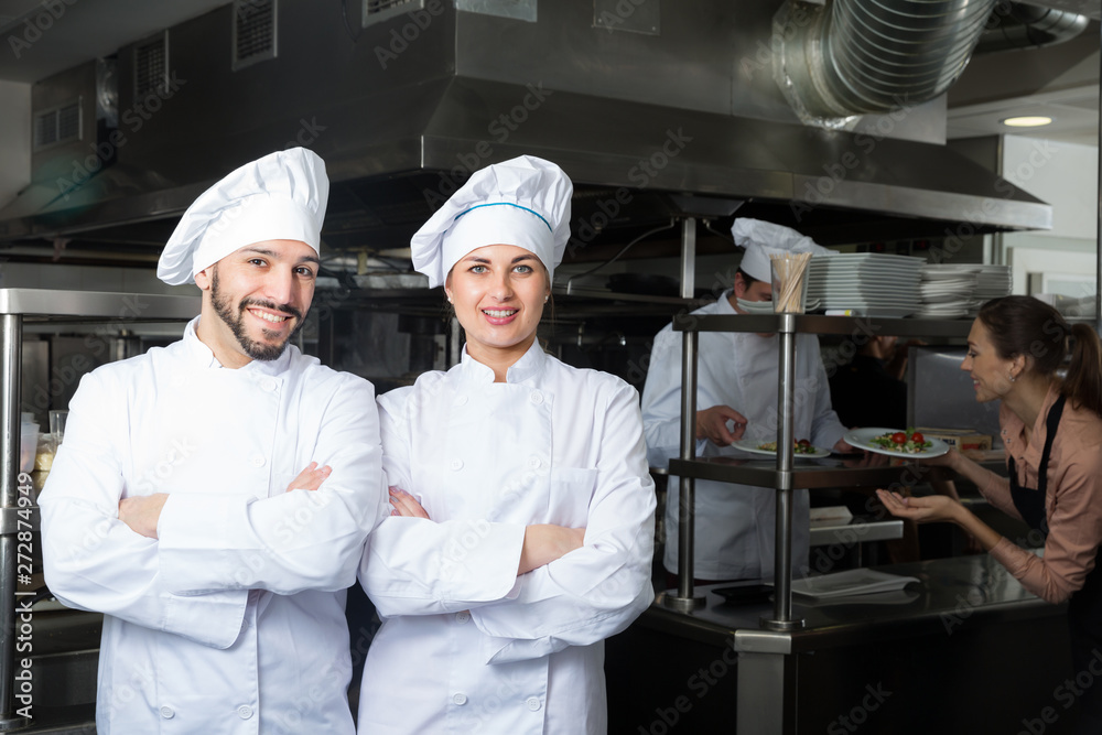 Two chefs in professional kitchen