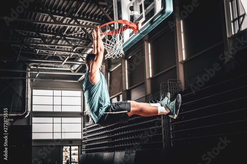 Black professional Black basketball player in action in a basketball court. © Fxquadro