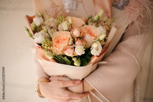 Fototapeta Naklejka Na Ścianę i Meble -  Lush bouquet of roses in peach wrapping