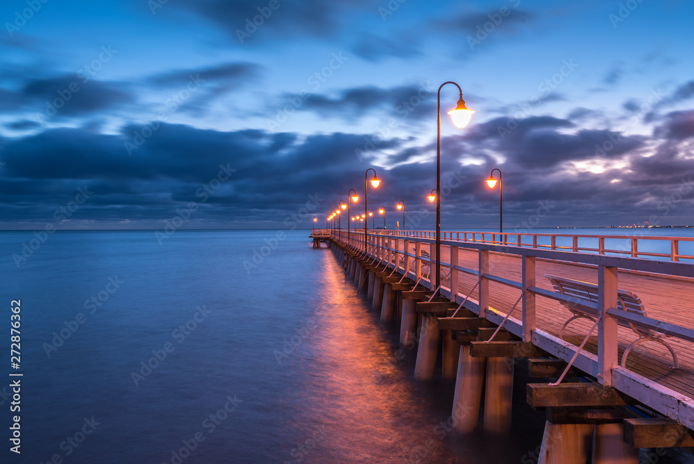 Naklejka premium Illuminated wooden pier in Gdynia Orlowo. Poland.