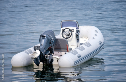 Inflatable White Motor Boat Floating At Sea