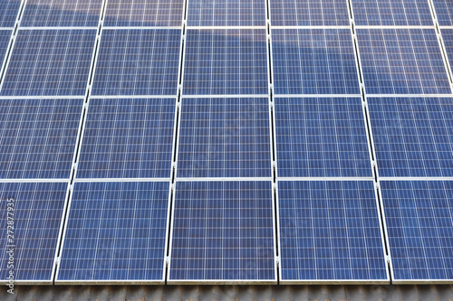 The surface of the solar panels close-up, mounted on the roof of the house. Full frame coverage with solar panels