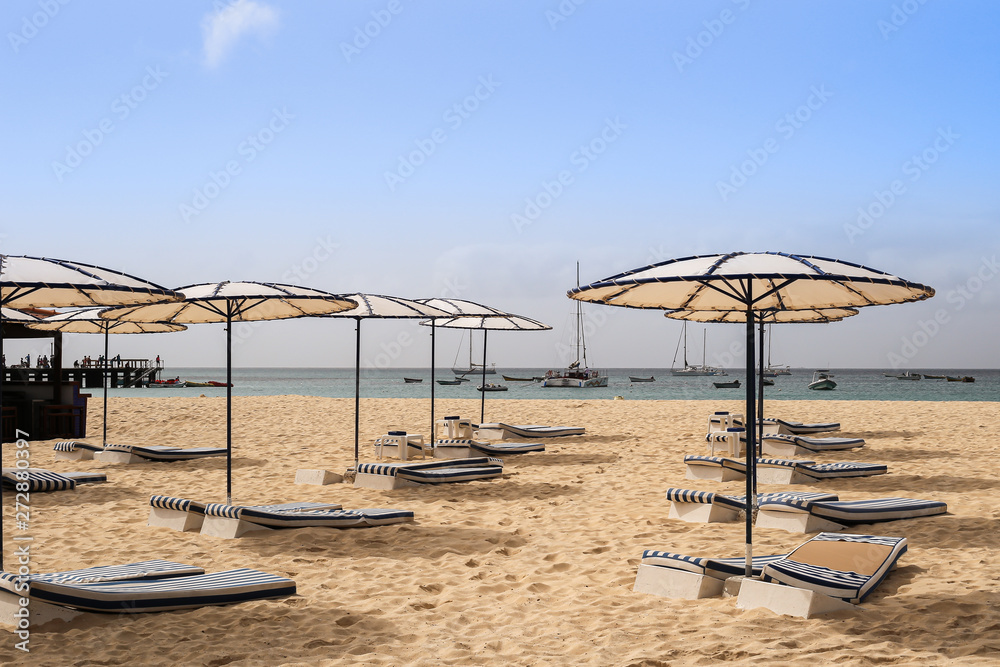 Beach with sun umbrellas and beds Beach with sun umbrellas and beds