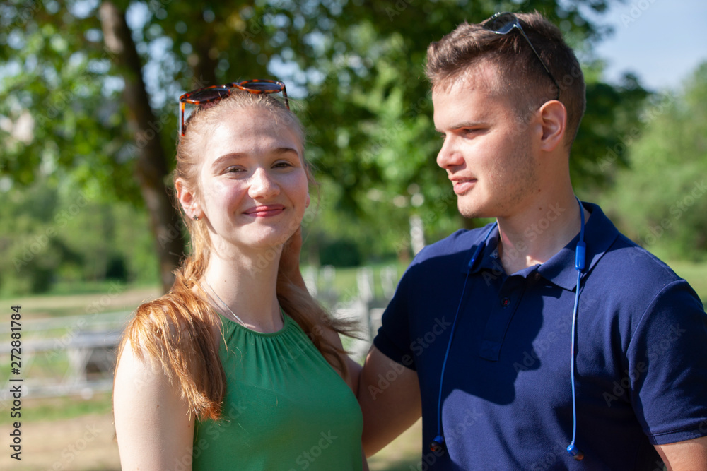 Beautiful loving couple flirting in the park on beautiful sunny day Beautiful loving couple flirting in the park on beautiful sunny day