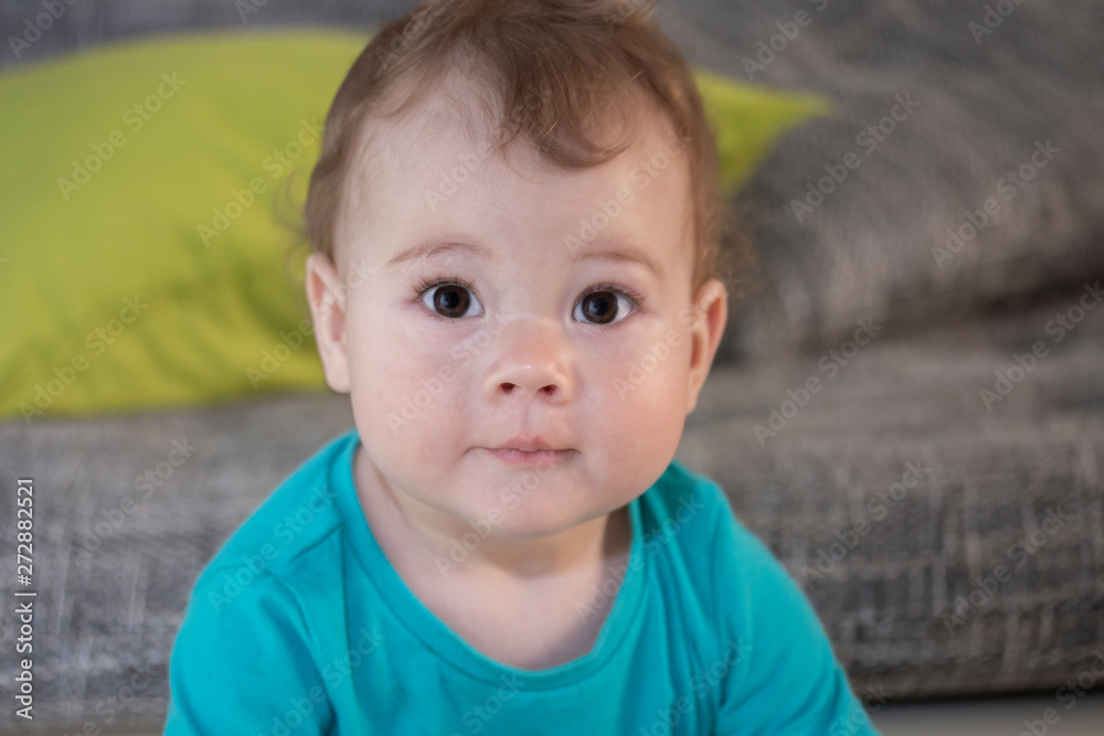 Portrait of a cute surprised toddler girl boy of 10 months. Baby looks with surprised eyes. A large portrait of a funny surprised little child, soft focus Portrait of a cute surprised toddler girl boy of 10 months. Baby looks with surprised eyes. A large portrait of a funny surprised little child, soft focus
