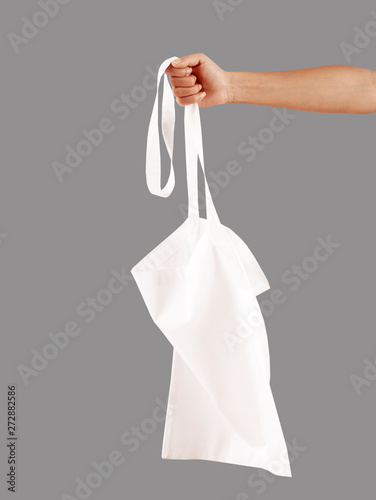 young woman holding cotton bag 