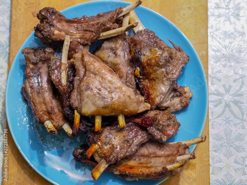 Delicious food is on the plate. Big chunks of meat on the rib. Fresh food. Close-up photo. Top view