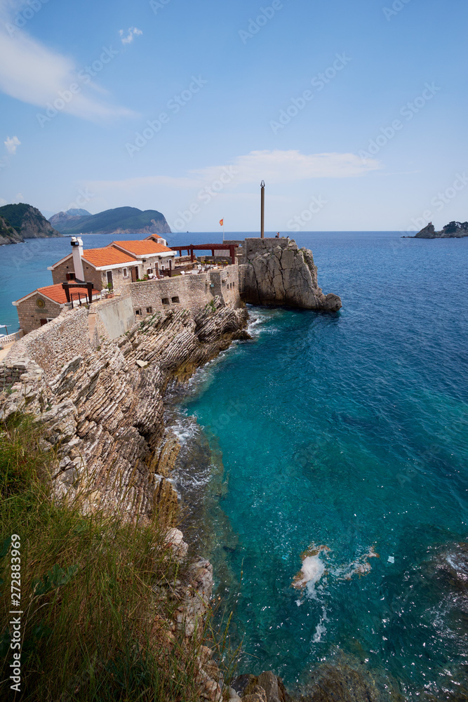 view of the island of Sveta Nedjelja and the village of Petrovac from a height in the afternoon.