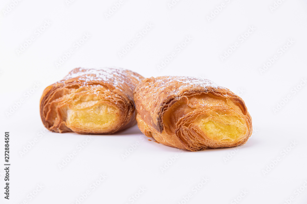 Two puff pastry rolls with powdered sugar Two puff pastry rolls with powdered sugar