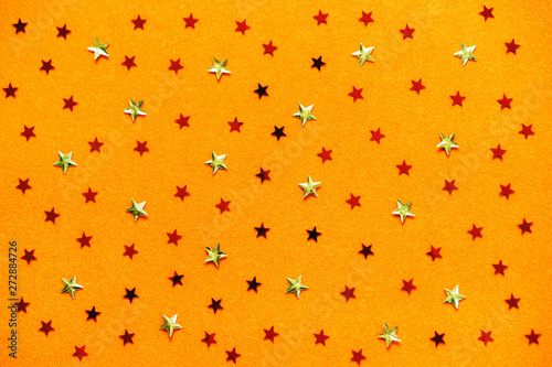 Orange background with yellow and red stars. Festive abstract concept. Background, great design for any purposes. Night party background