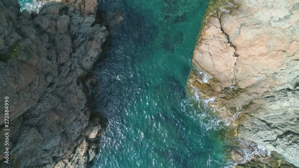 Aerial view of pure transparent blue turquoise tropical ocean water with light reflections and waves breaking between rocky mountains. Summer texture background Aerial view of pure transparent blue turquoise tropical ocean water with light reflections and waves breaking between rocky mountains. Summer texture background
