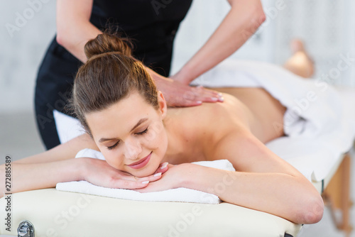 Beautiful caucasian woman during massage in spa salon.