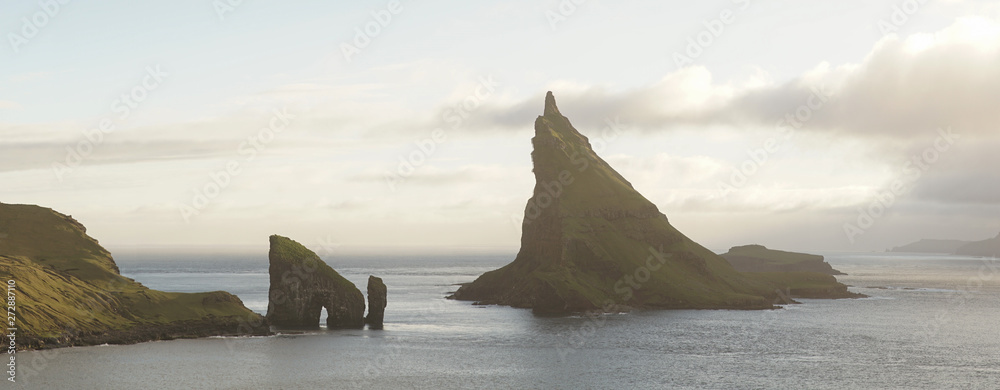 Drangarnir Sea Stack Mountain Hike near Sorvagur during sunset on the Faroe Islands in the Atlantic Ocean. - obrazy, fototapety, plakaty 