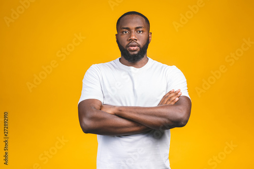 Portrait of handsome young african american man smiling isolated yellow background.