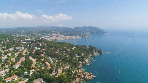 Wallpaper Mural Summer Costa Brava rocky coastline. Aerial view of sideways flight over transparent blue turquoise Mediterranean sea, yacht and view of small Spanish city and luxury villas. Palafrugell, Catalonia, Sp Torontodigital.ca