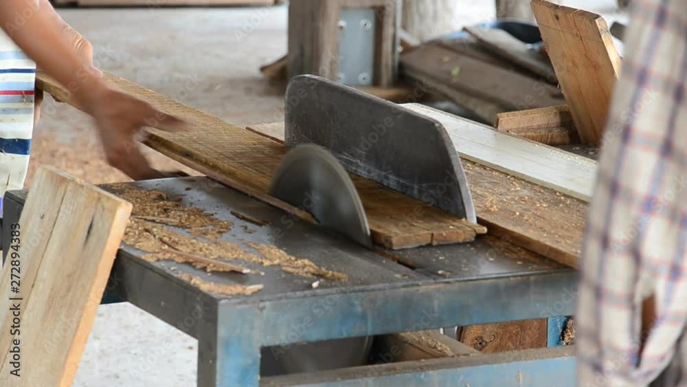 Carpenter was sawing wood for construction. Carpenter was sawing wood for construction.