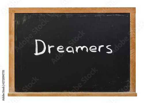 Dreamers written in white chalk on a black chalkboard isolated on white