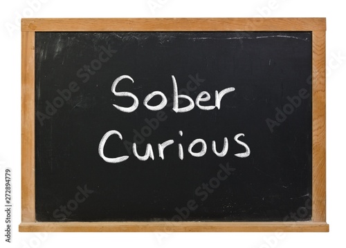 Obraz na plátně Sober curious written in white chalk on a black chalkboard isolated on white