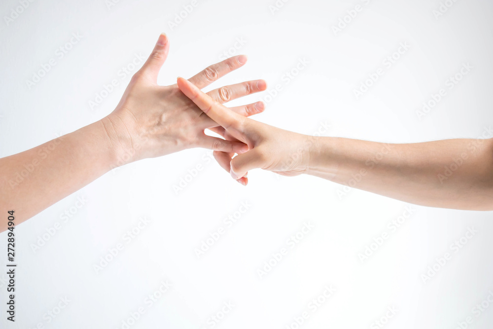 Hands of two people playing rock paper scissors; hands showing shape of scissors symbol and paper symbol; concept of business competition. Hands of two people playing rock paper scissors; hands showing shape of scissors symbol and paper symbol; concept of business competition.