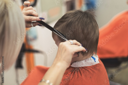 A little boy's haircut in a hairdresser's.