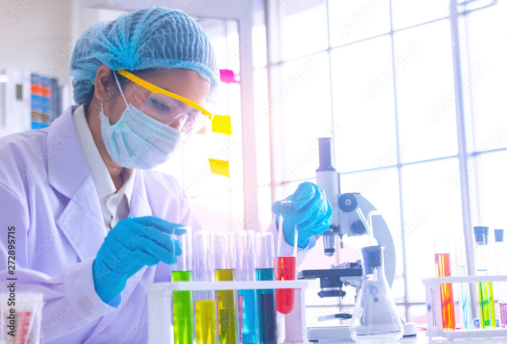 Body past scientist working in laboratory.She is trying and research with red and blue test tube. Experiment , chemical Photo concept develop and medicine. Body past scientist working in laboratory.She is trying and research with red and blue test tube. Experiment , chemical Photo concept develop and medicine.