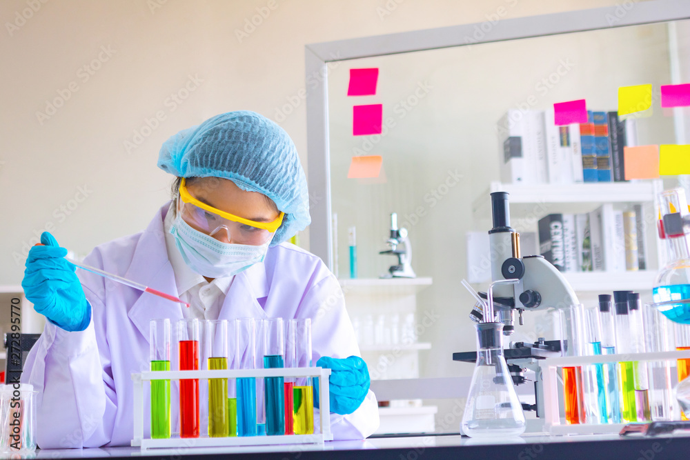 Body past scientist working in laboratory.She is trying and research with red and blue test tube. Experiment , chemical Photo concept develop and medicine. Body past scientist working in laboratory.She is trying and research with red and blue test tube. Experiment , chemical Photo concept develop and medicine.