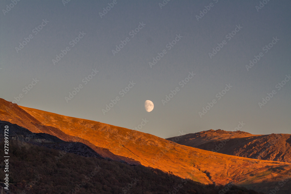 Moon rising over welsh hillside
