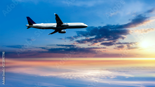 Airplane in the sky at sunrise . Plane Background Blue Sky White Clouds