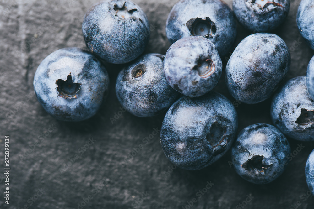 Fresh blueberry on stones background. Texture blueberry berries close up. Vegan and vegetarian concept. Fresh blueberry on stones background. Texture blueberry berries close up. Vegan and vegetarian concept.