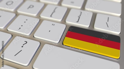 Key with flag of New Zealand on the keyboard switches to key with flag of Germany, translation or relocation related animation photo