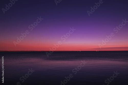 Blue sea  pink orange sky at sunset. Summer sea scenic landscape on sunny evening