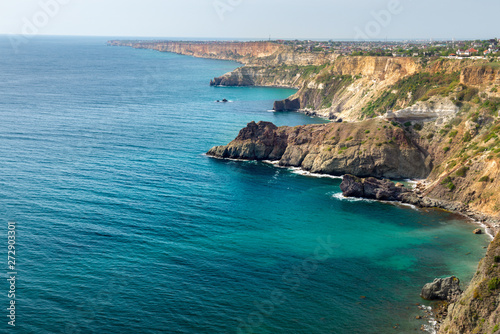 Fiolent Cape Crimea Black Sea. Blue azure seaside with corals sand and stones