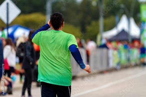 Young man running a marathon reaching the final line