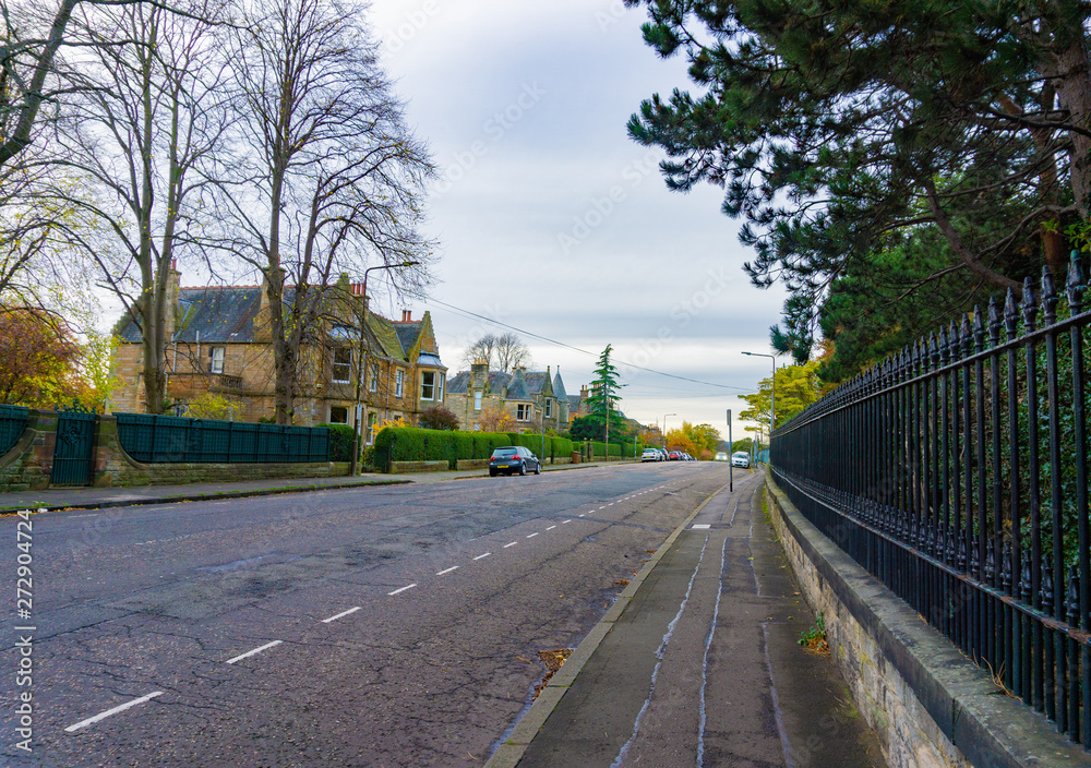 Side road view with trees and European style house Side road view with trees and European style house