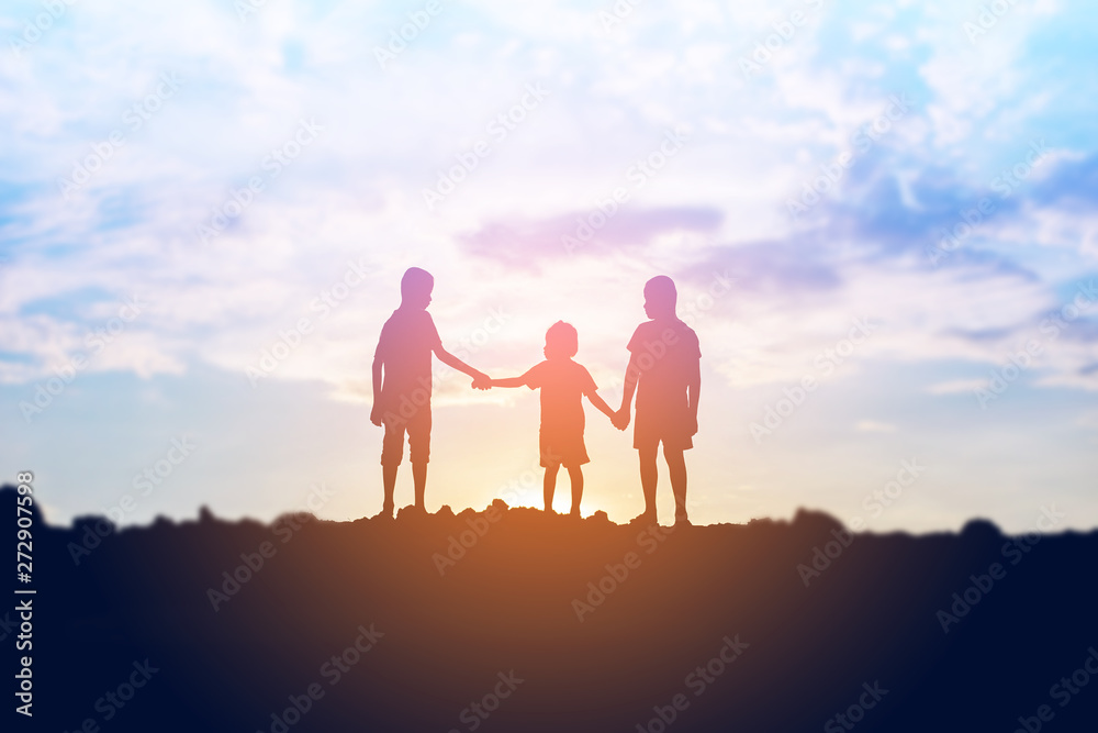 silhouette of a happy children and happy time sunset - obrazy, fototapety, plakaty 