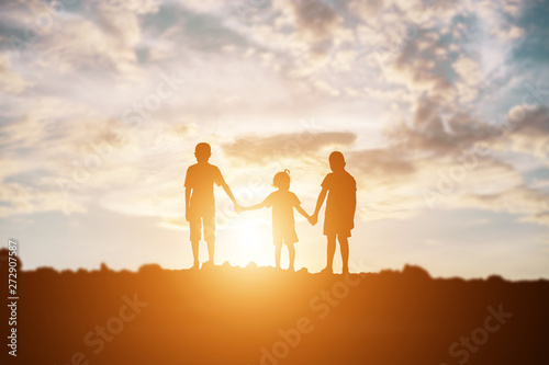 silhouette of a happy children and happy time sunset