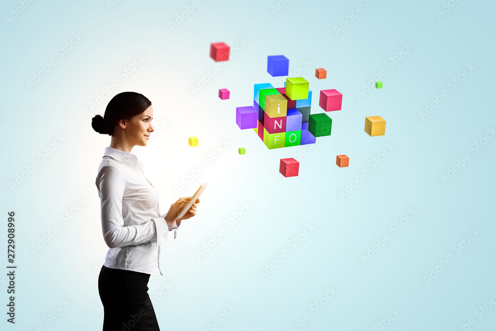 Businesswoman holding a tabalet with cube puzzle. Mixed media Businesswoman holding a tabalet with cube puzzle. Mixed media