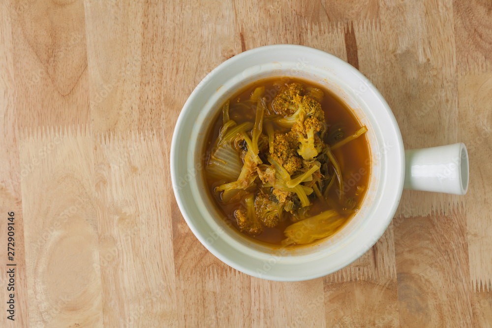 Sour soup made of Tamarind and Vegetable on bowl wooden background. Sour soup made of Tamarind and Vegetable on bowl wooden background.