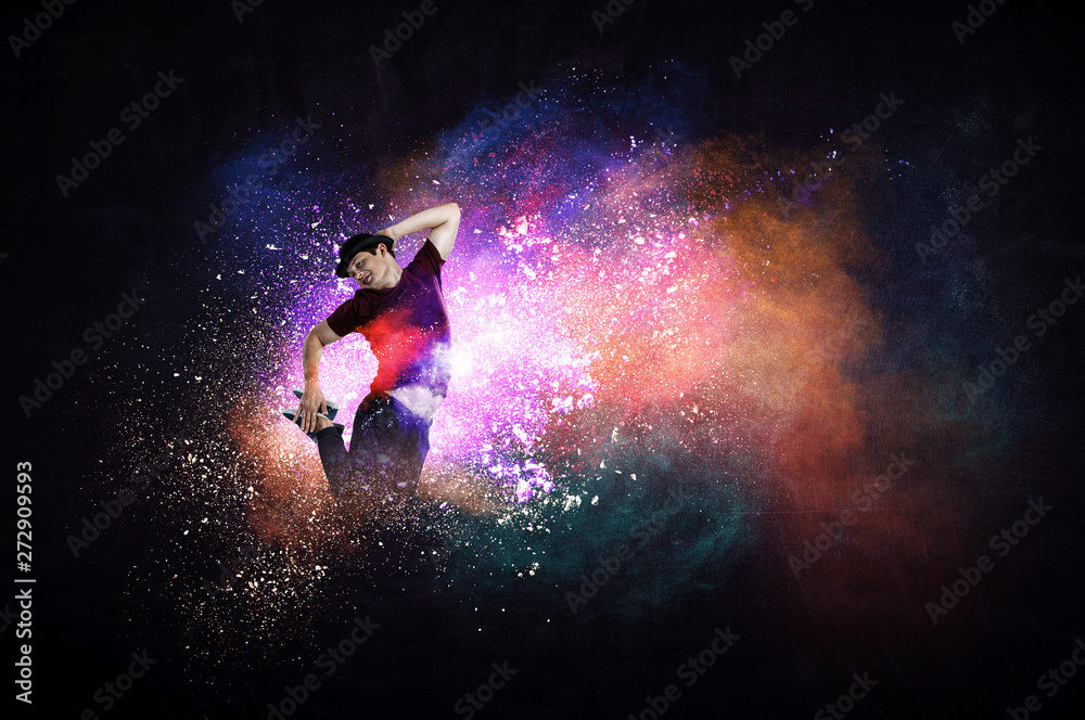 Modern dancer jumping with colourful splashes background. Mixed media