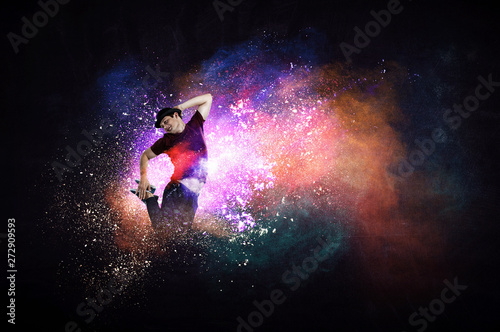 Modern dancer jumping with colourful splashes background. Mixed media