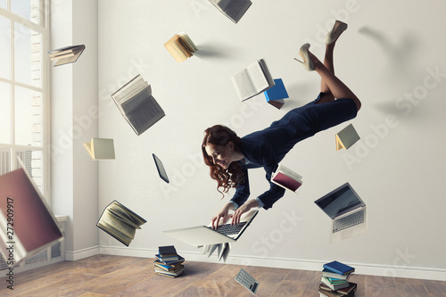 Joyful beautiful young levitating businesswoman. Mixed media photo