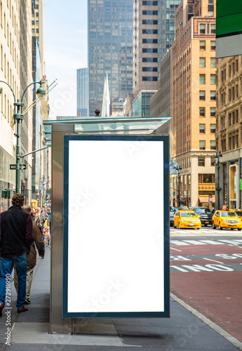 Blank billboard at bus stop for advertising, New York city buildings and street background