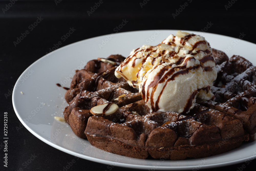chocolate Belgian waffles topped with almonds chocolate syrup and ice-cream chocolate Belgian waffles topped with almonds chocolate syrup and ice-cream