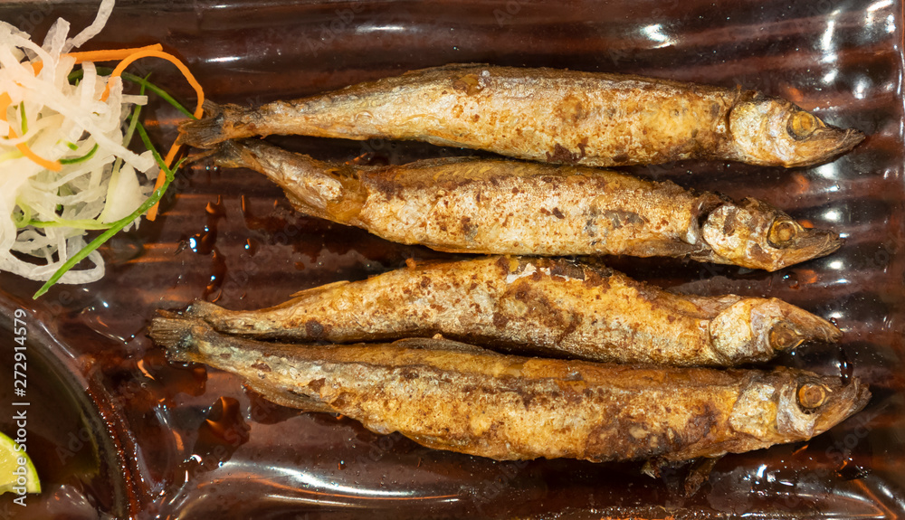 shishamo grilled placed in a plate. shishamo grilled placed in a plate.
