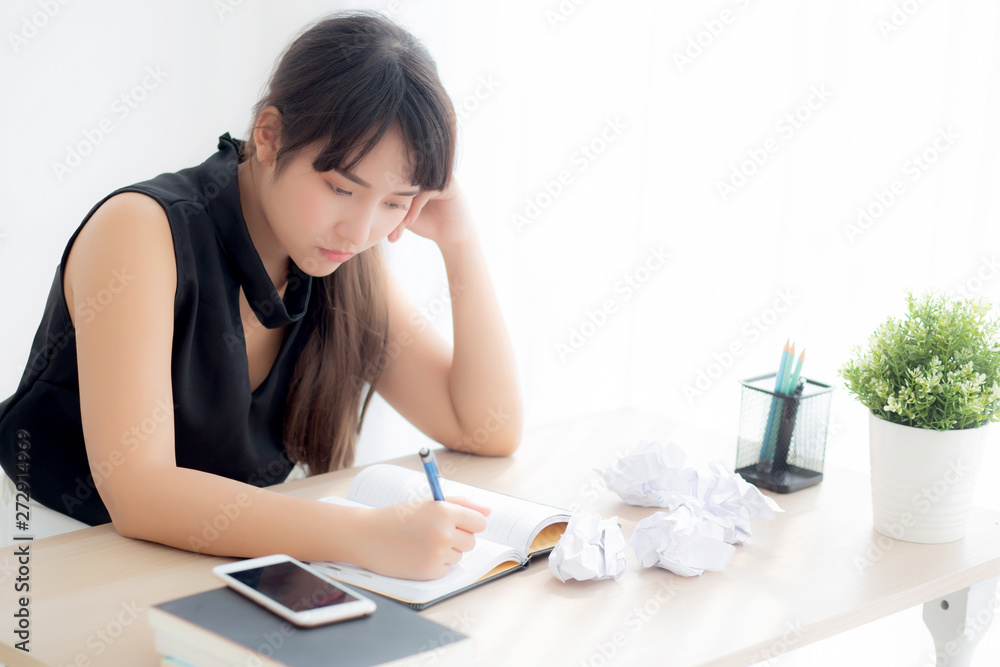 Beautiful asian woman tired and stressed with writing overworked at desk, girl with worried not idea with notebook and crumpled paper at office, freelance and business concept. Beautiful asian woman tired and stressed with writing overworked at desk, girl with worried not idea with notebook and crumpled paper at office, freelance and business concept.