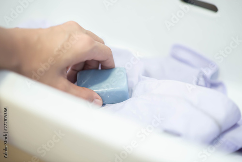 Woman s hand washing white shirt boy school uniform