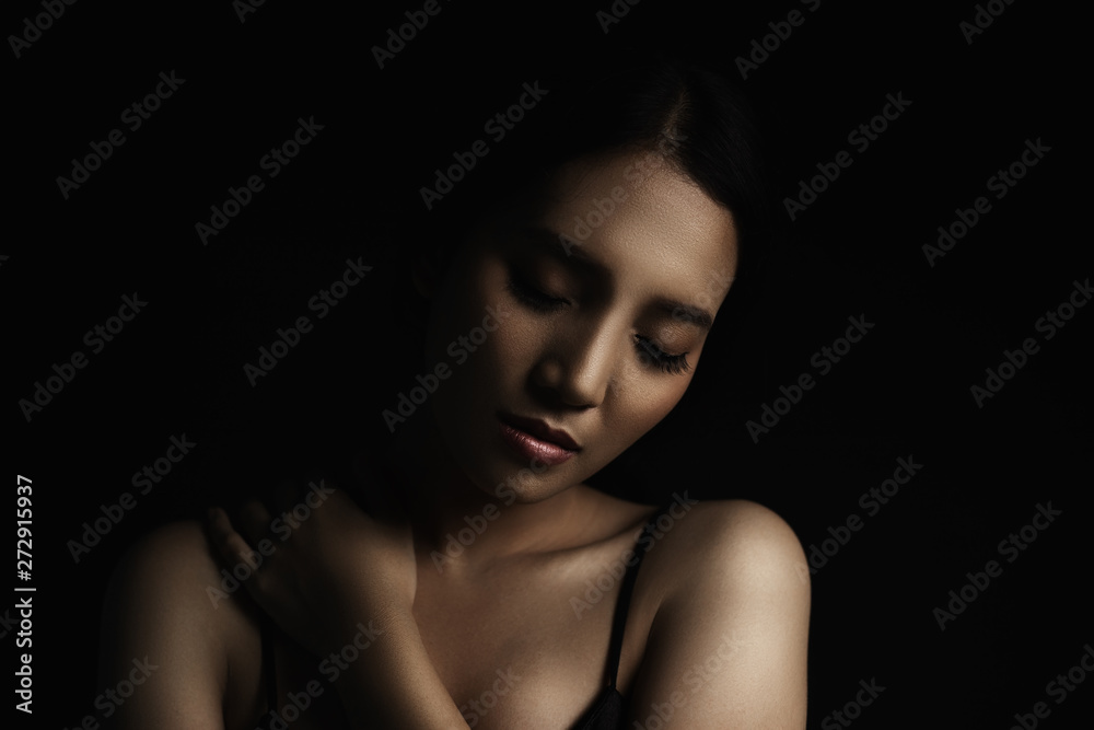 beautiful young woman closeup face and glossy skin under glamour low key concept beautiful young woman closeup face and glossy skin under glamour low key concept
